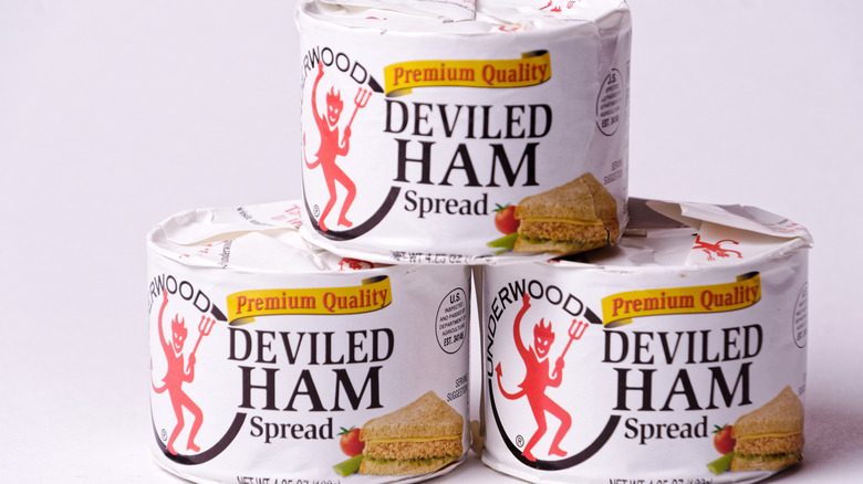 Cans of Underwood Deviled Ham Spread piled atop one another