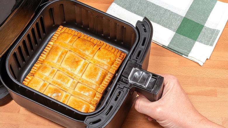Baked, square-shaped pie in air fryer basket