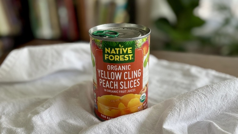Native Forest Organic Yellow Cling Peach Slices on table in front of shelf