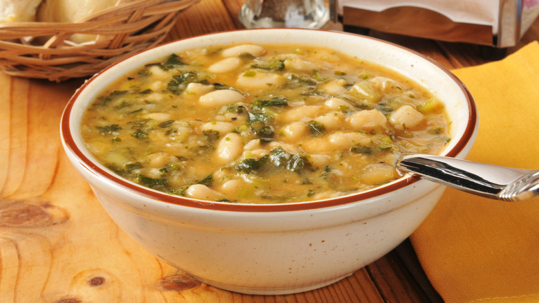 Bowl of soup with beans in it.