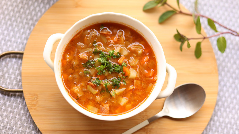 Bean and bacon soup on a cutting board