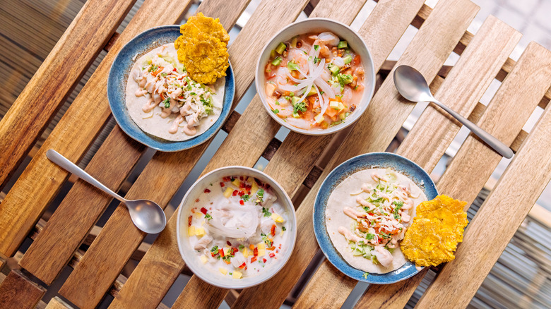 Four bowls of ceviche on picnic table