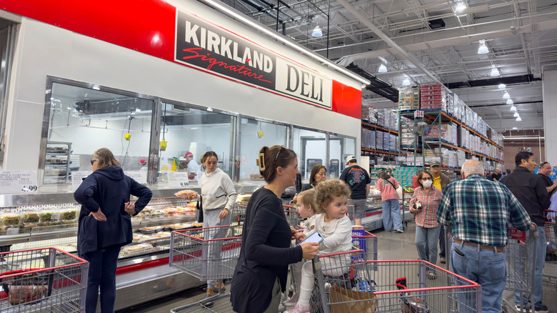 Costco customers shop near the Kirkland Signature deli