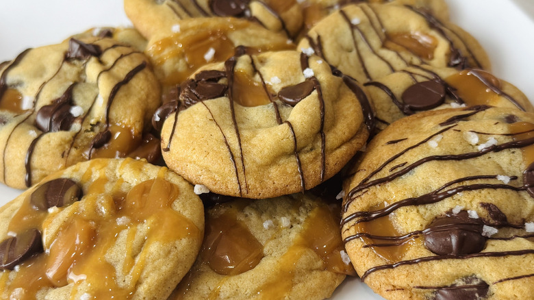 closeup shot of pile of chocolate chip and caramel cookies
