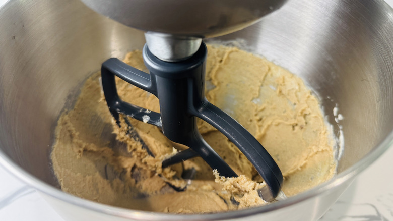 Paddle attachment beating butter and sugar in stand mixer