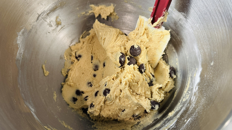 Spatula used to mix chocolate chip cookie dough in bowl