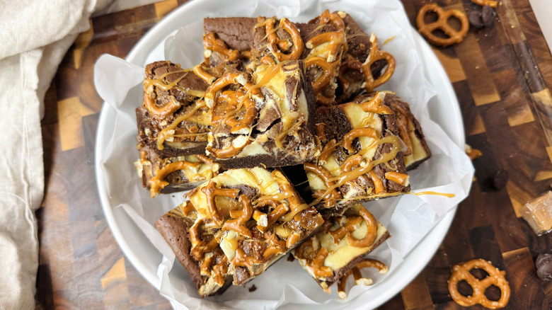 Caramel pretzel brownies stacked in bowl