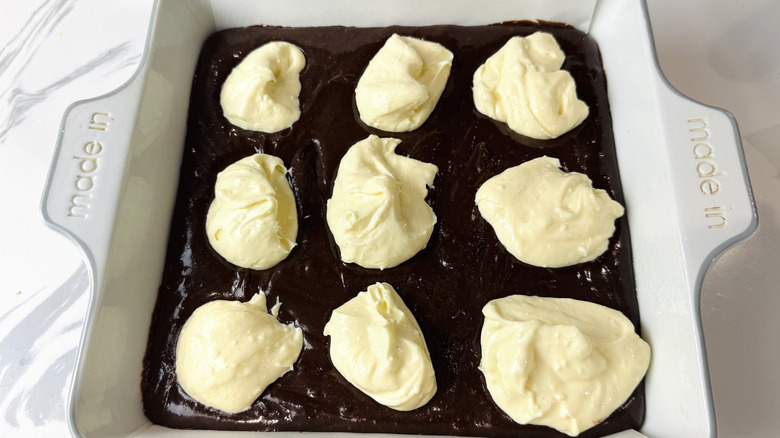 Brownie batter topped with dollops of cream cheese mixture
