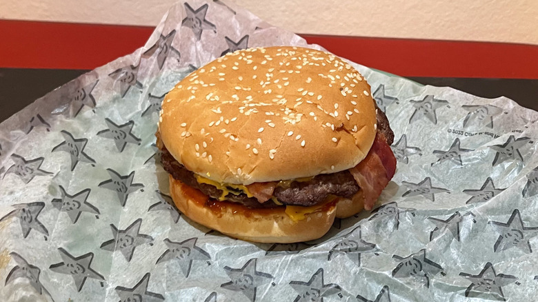 A Double Western Bacon Cheeseburger from Carl's Jr. sitting on its wrapper