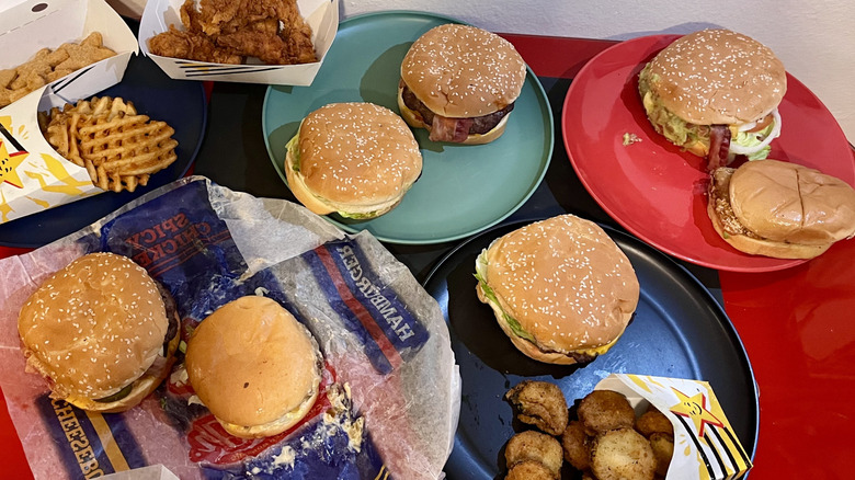 A table of 11 Carl's Jr. menu items on plates