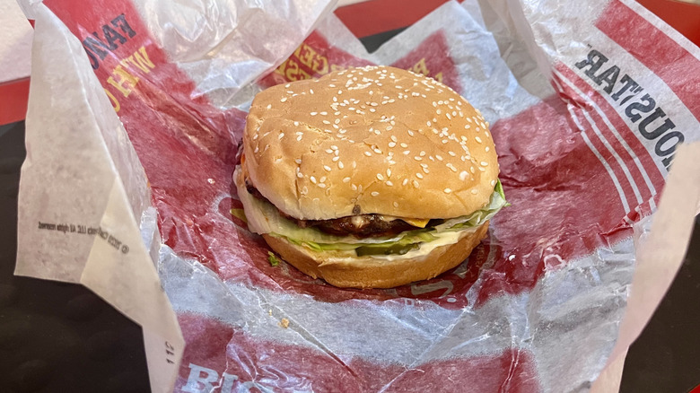 A Single Famous Star Burger from Carl's Jr. sitting on its wrapper