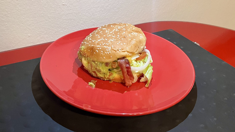 A Single Guacamole Bacon Burger from Carl's Jr. sitting on a plate