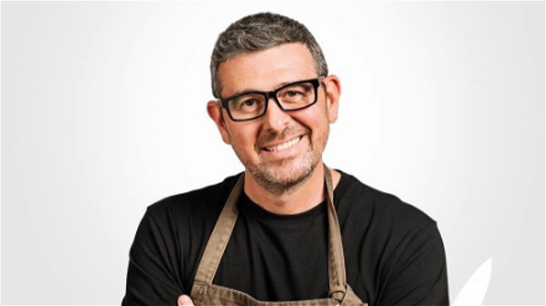 Billy Parisi wearing a black shirt and smiling