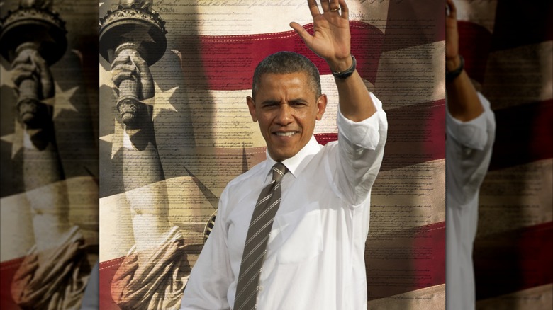 Obama waving with a statue of Liberty and American flag backdrop