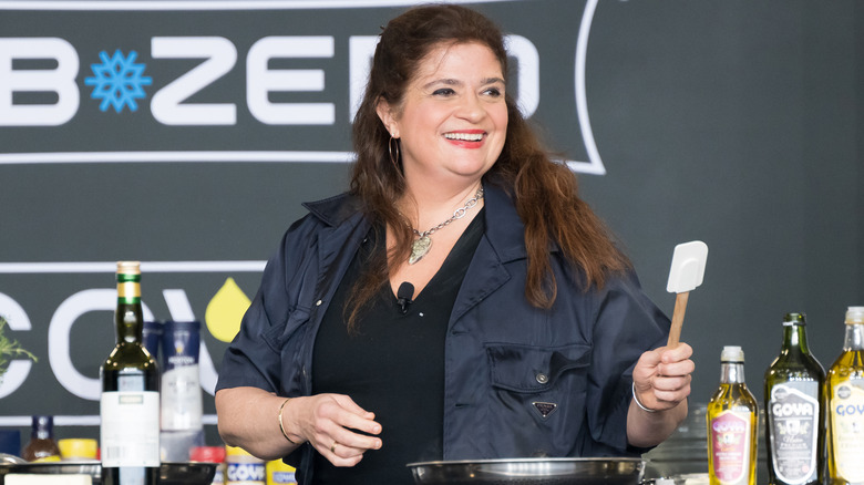 Alex Guarnaschelli giving a cooking demonstration at an event