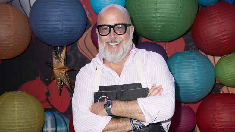 Andrew Zimmern standing in front of paper lanterns