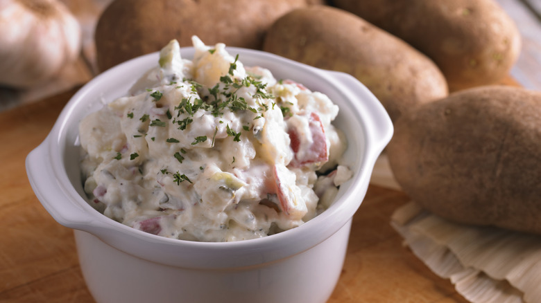 A creamy bowl of potato salad on a table.