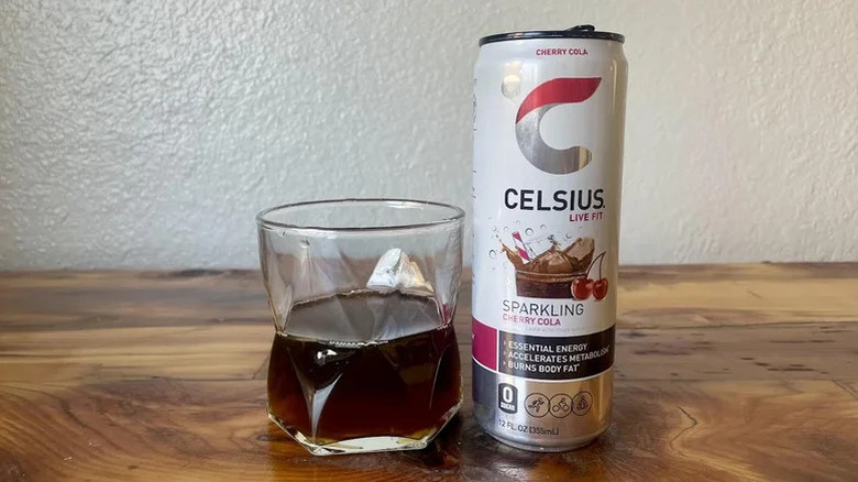 Can of Celsius Sparkling Cherry Cola flavor and a filled glass cup