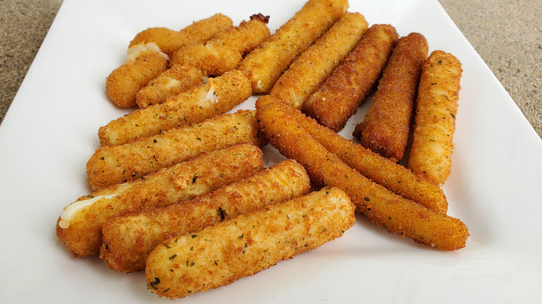 White plate filled with various mozzarella sticks