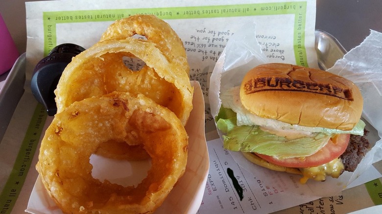 BurgerFi's onion rings served alongside a BurgerFi burger