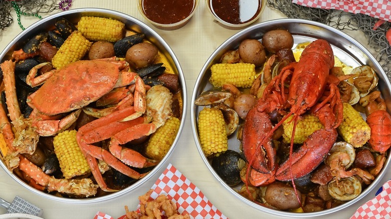 Two seafood boil bowls on a table at Angry Crab Shack