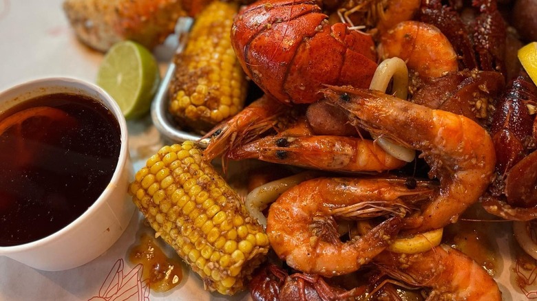 A close-up of a seafood boil with sauce at Cap't Loui