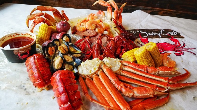 A seafood boil on a sheet of plastic at The Juicy Crab