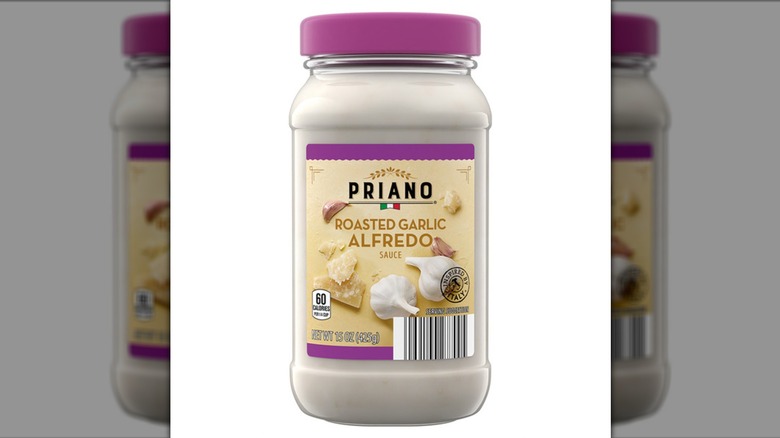 Jar of Priano Roasted Garlic Alfredo Sauce on a white background.