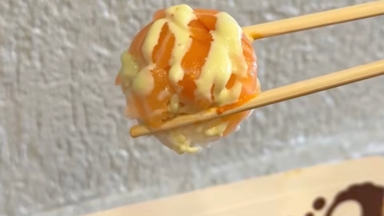 sushi ball held by chopsticks