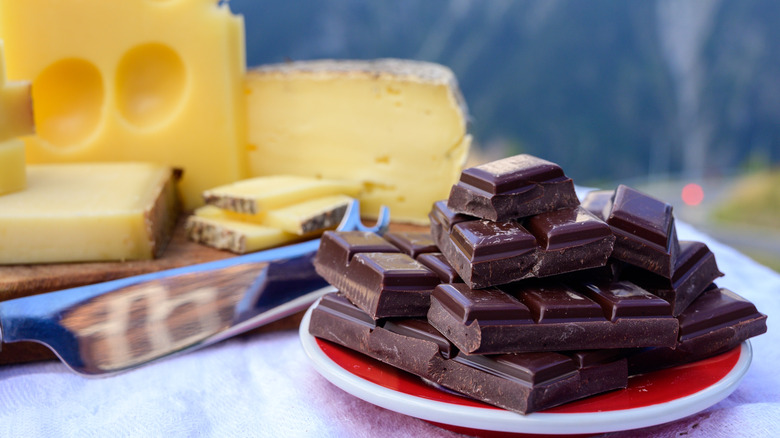 Chocolate on plate with Swiss cheese in background