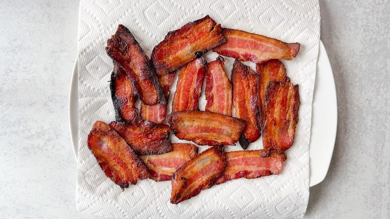 Crispy maple-glazed bacon on paper towel-lined plate
