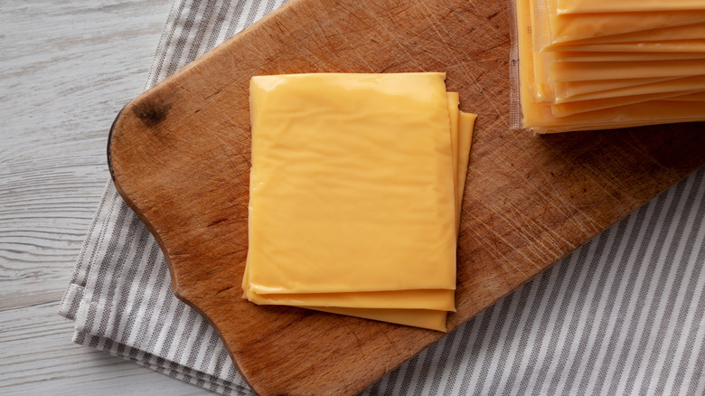 slices of American cheese on wooden board
