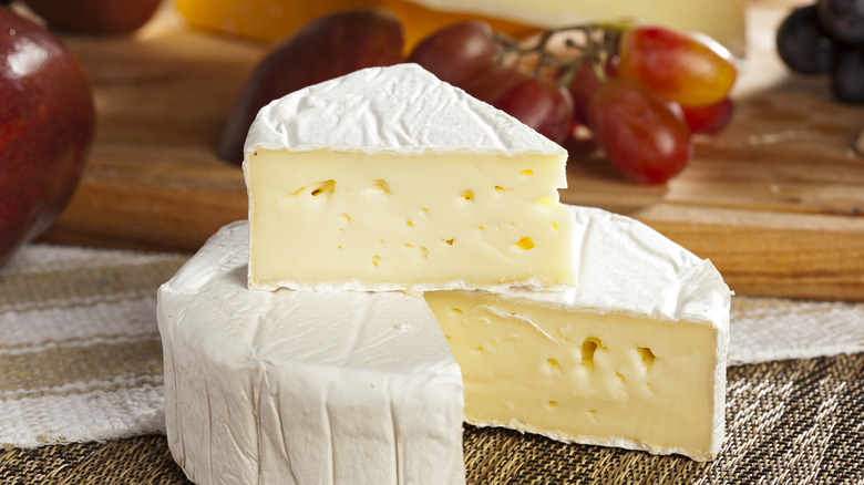 triangle of brie cut from brie wheel and stacked on top