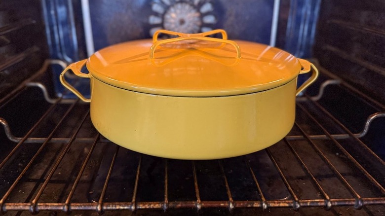 Covered yellow braiser in oven