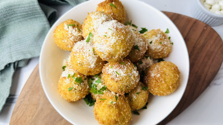 Fried mashed potato balls garnished with parmesan and parsley