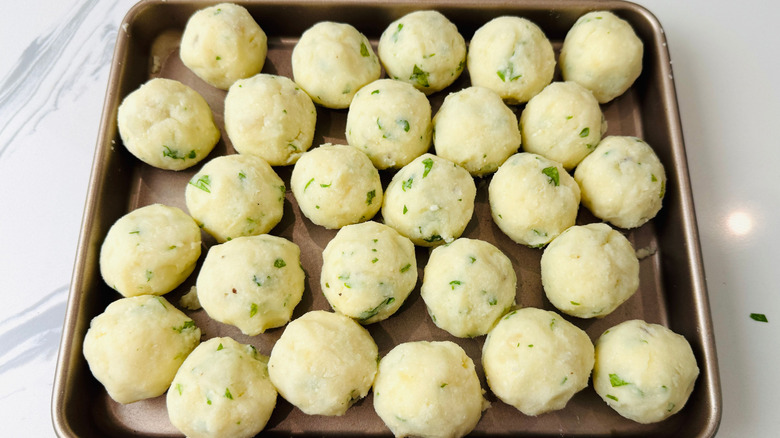 Mashed potato balls on baking sheet