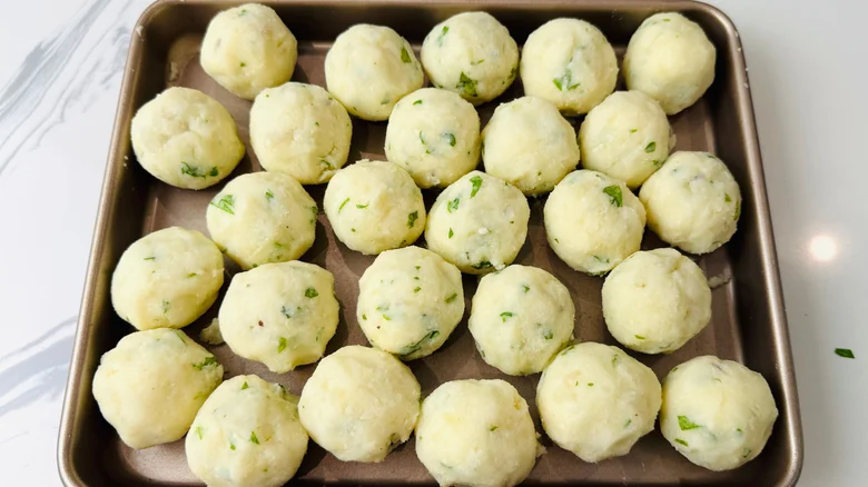 Mashed potato balls on baking sheet