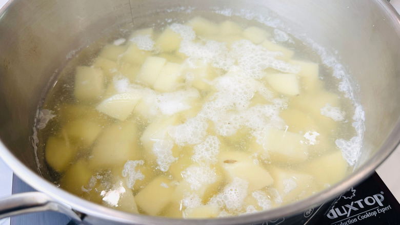 Diced potatoes boiling in pot of water