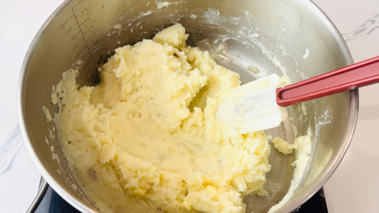 Mashed potatoes in bowl with rubber spatula