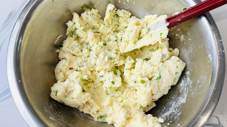 Mashed potatoes in bowl with rubber spatula