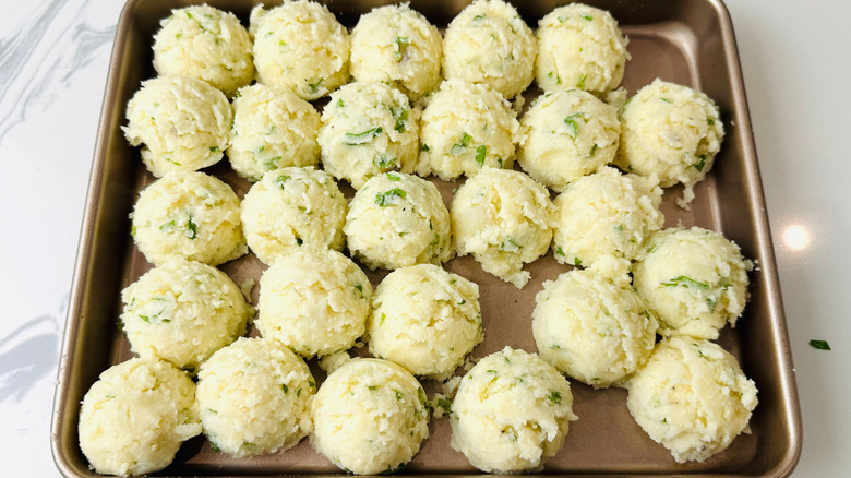Mashed potato balls on baking sheet