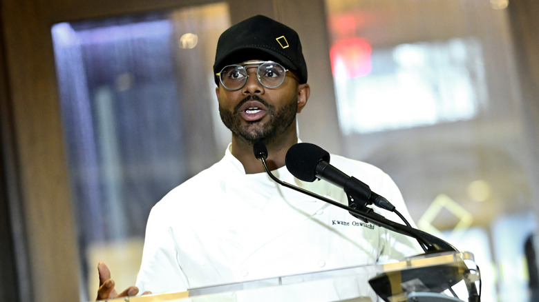 Chef Kwame Onwuachi speaking into a mic