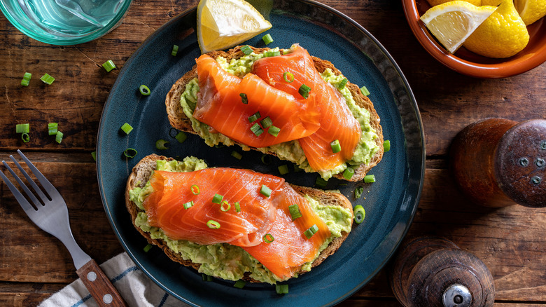 Salmon avocado toast on rustic plate