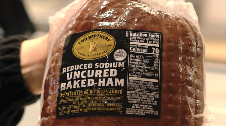 hands holding a two brothers uncured baked ham