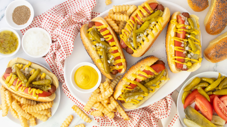 Overhead shot of several Chicago-style hot dogs and toppings