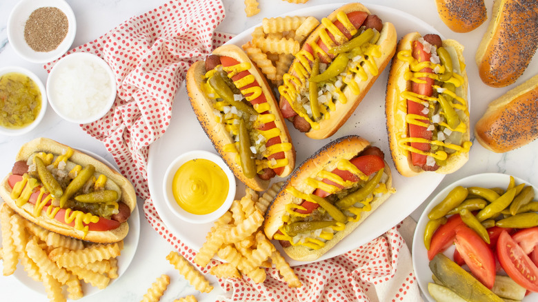 Overhead shot of several Chicago-style hot dogs and toppings