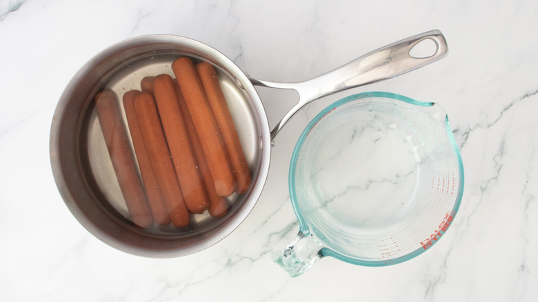 Hot dogs in a large saucepan covered with water
