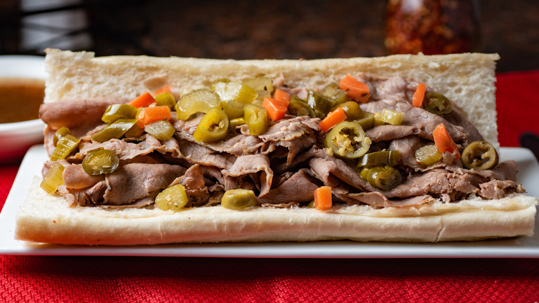 Open Italian beef sandwich with thinly sliced meat