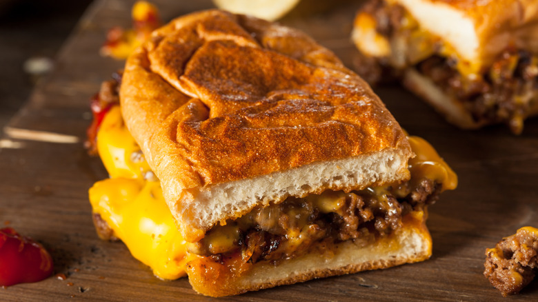 A chopped cheese sandwich on a wooden board