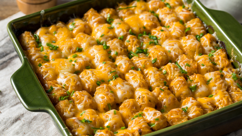 A cheesy chicken casserole with a sage background